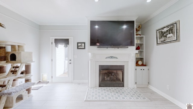 living room featuring a tiled fireplace, baseboards, and ornamental molding