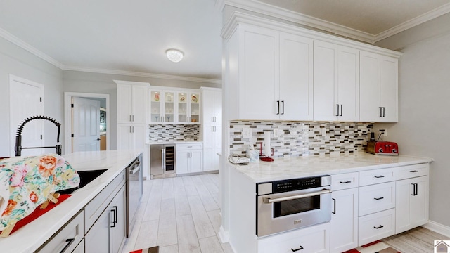 kitchen with light wood finished floors, white cabinetry, and stainless steel appliances