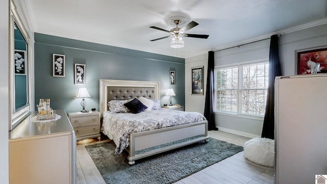 bedroom with baseboards, a ceiling fan, crown molding, and light wood finished floors