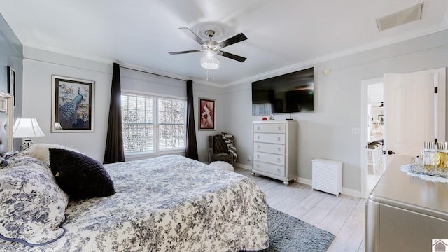 bedroom featuring light wood-type flooring, visible vents, crown molding, baseboards, and ceiling fan