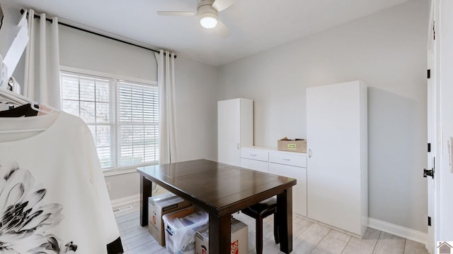dining area with a ceiling fan, baseboards, and wood finish floors