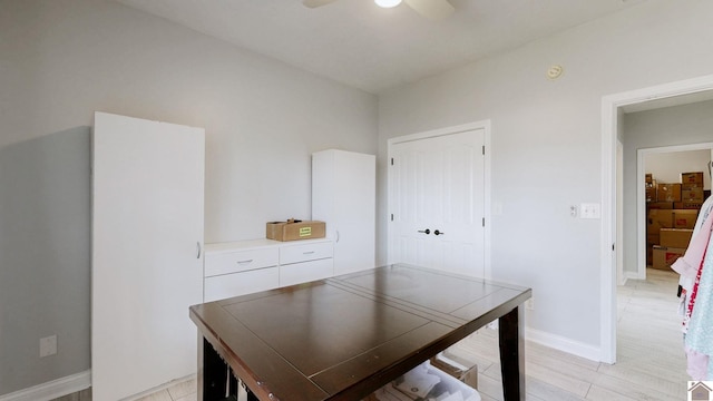dining space with baseboards and ceiling fan