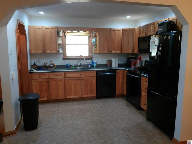 kitchen featuring black appliances, a sink, open shelves, dark countertops, and recessed lighting