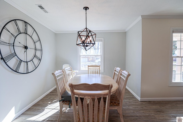 dining room featuring visible vents, ornamental molding, an inviting chandelier, and wood finished floors