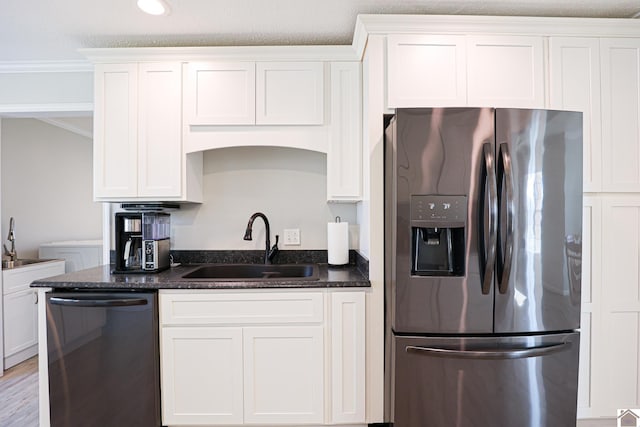 kitchen featuring stainless steel fridge, dishwasher, white cabinetry, and a sink