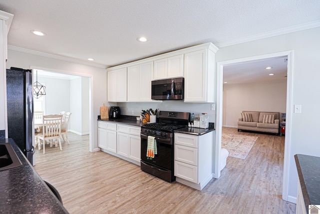 kitchen featuring black appliances, white cabinets, light wood finished floors, and ornamental molding