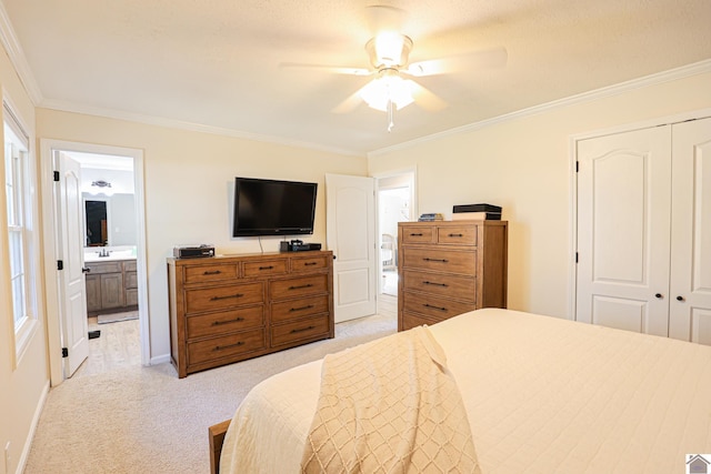 bedroom featuring ensuite bath, ornamental molding, a closet, and light carpet