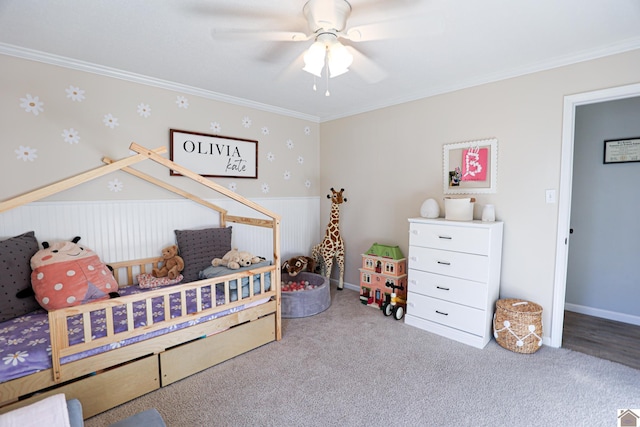 bedroom with crown molding, a wainscoted wall, carpet floors, and ceiling fan