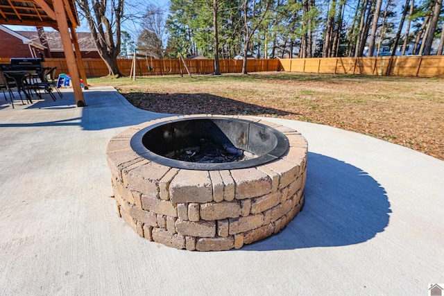 exterior space featuring a fire pit and a fenced backyard