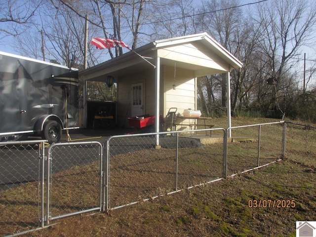 view of property exterior with fence and a gate