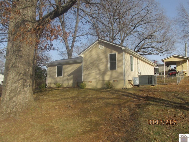 view of side of property featuring crawl space, central AC unit, and fence