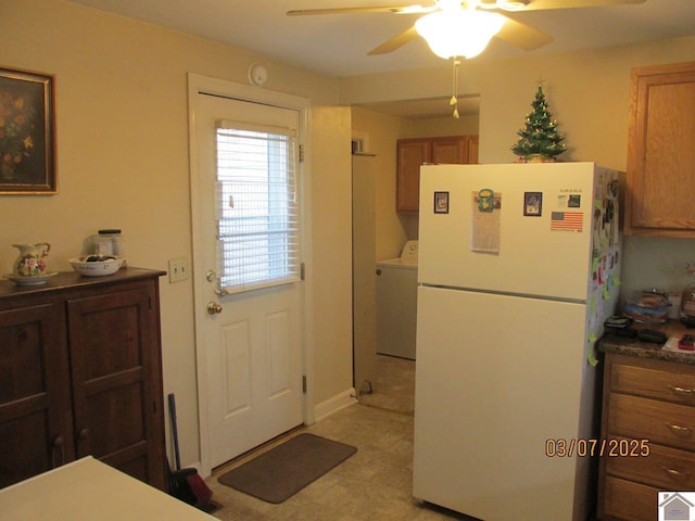 doorway to outside featuring light floors, washer / clothes dryer, and a ceiling fan