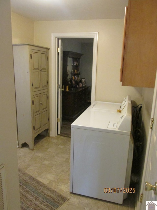 clothes washing area featuring visible vents and washer and dryer