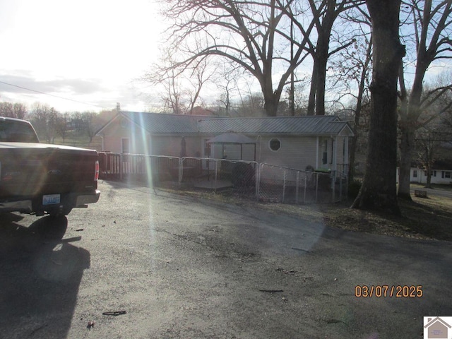 exterior space with fence and metal roof