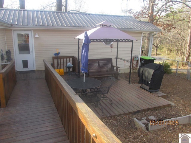 wooden terrace featuring a gazebo, area for grilling, and fence