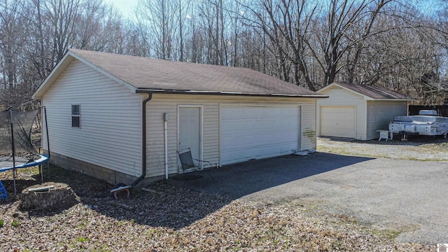 detached garage featuring a trampoline