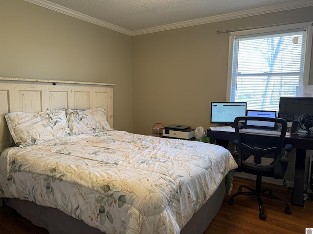 bedroom with a textured ceiling, wood finished floors, and ornamental molding