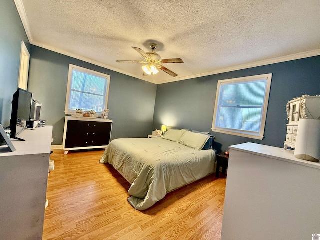 bedroom with ceiling fan, a textured ceiling, light wood-style flooring, and ornamental molding