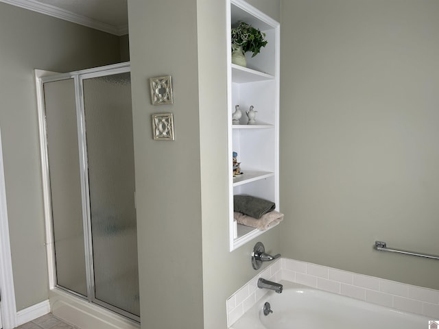 bathroom with a shower stall, built in shelves, a garden tub, and ornamental molding