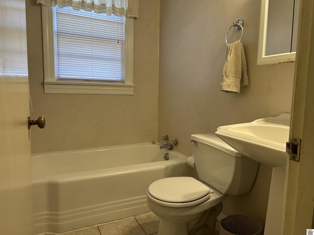 full bathroom with toilet, a tub to relax in, and tile patterned flooring