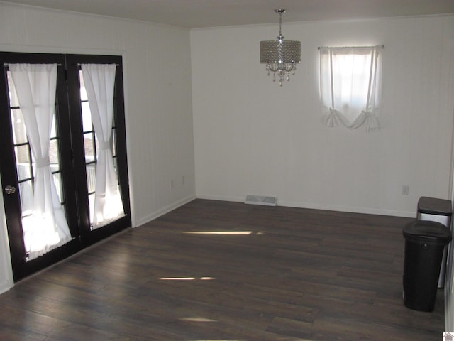 interior space with visible vents, baseboards, dark wood-type flooring, and a chandelier