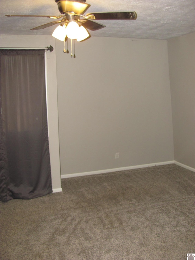 carpeted empty room with baseboards, a textured ceiling, and a ceiling fan