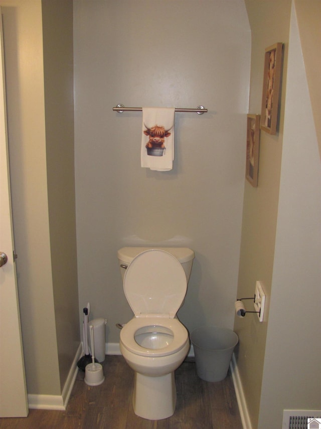 bathroom featuring visible vents, toilet, baseboards, and wood finished floors