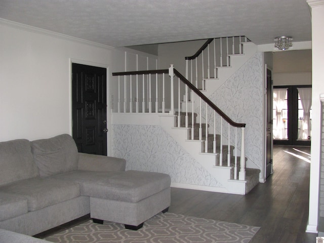 living room with crown molding, stairway, a notable chandelier, and wood finished floors