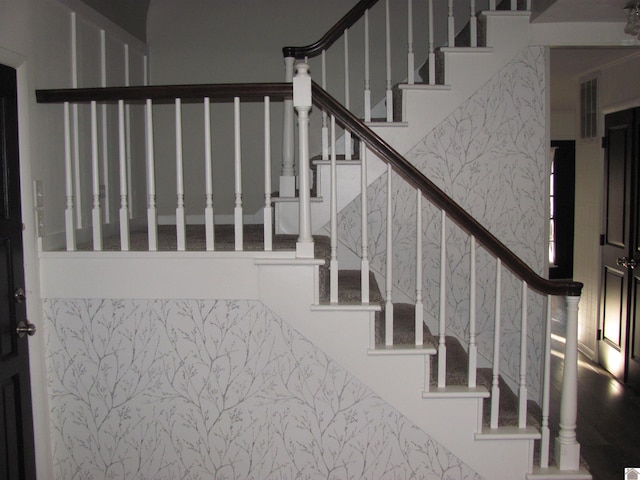 stairs with visible vents and wallpapered walls