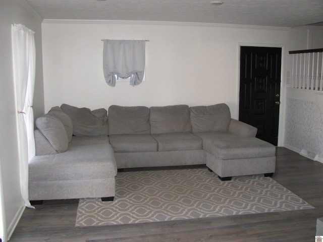 living room with crown molding, wood finished floors, and baseboards