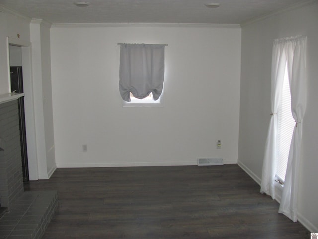 interior space with visible vents, baseboards, dark wood-style flooring, and crown molding