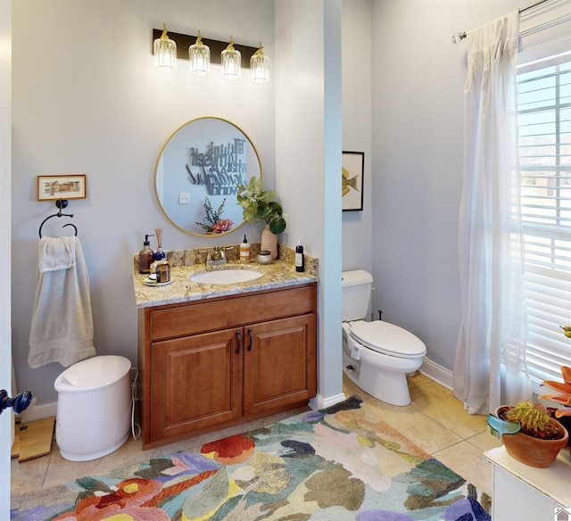 bathroom featuring toilet, vanity, and tile patterned flooring