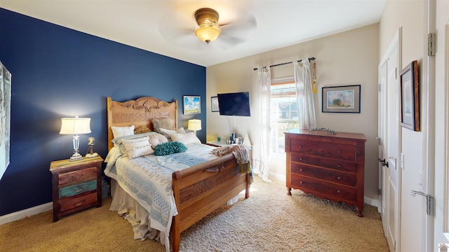 bedroom with a ceiling fan, carpet, and baseboards