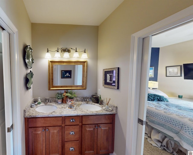 ensuite bathroom with a sink, ensuite bath, and double vanity