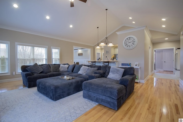 living room with baseboards, light wood-style flooring, and crown molding