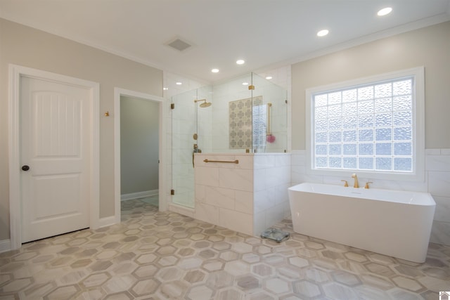 bathroom with visible vents, tiled shower, a freestanding bath, ornamental molding, and tile walls