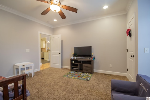 carpeted living area featuring recessed lighting, a ceiling fan, crown molding, and baseboards