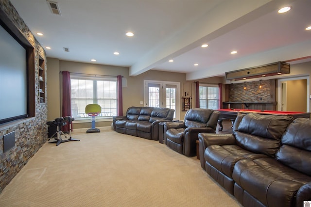 carpeted cinema with beamed ceiling, recessed lighting, visible vents, and french doors