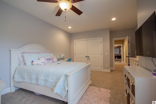 bedroom featuring light carpet, a ceiling fan, recessed lighting, a closet, and baseboards