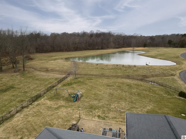 exterior space featuring a water view, a view of trees, and fence