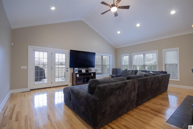 living area with light wood finished floors, high vaulted ceiling, crown molding, and baseboards