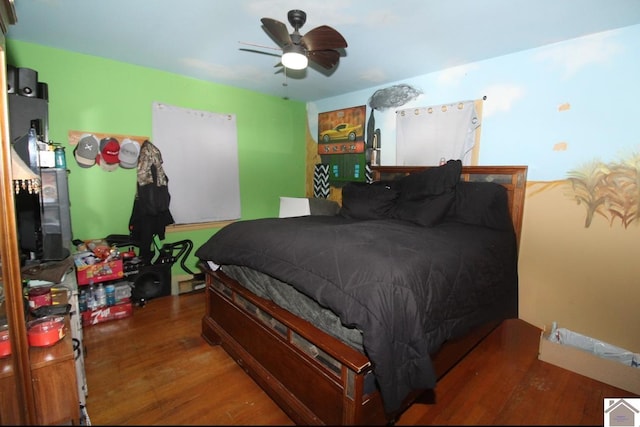 bedroom with ceiling fan and wood finished floors