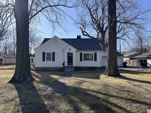 view of front facade featuring a garage, a chimney, roof with shingles, and fence