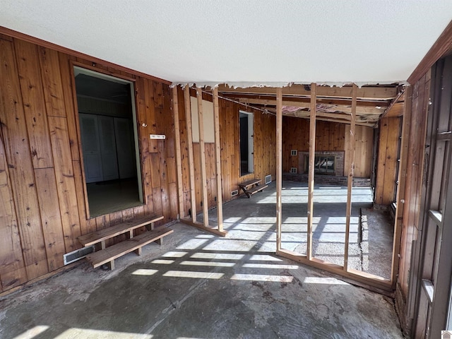 miscellaneous room featuring wooden walls