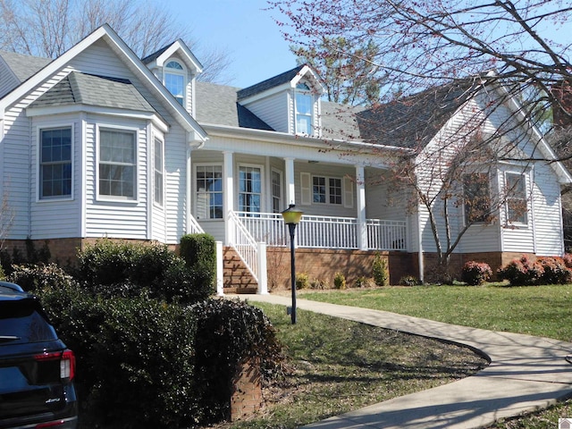 cape cod-style house with a porch and a front lawn