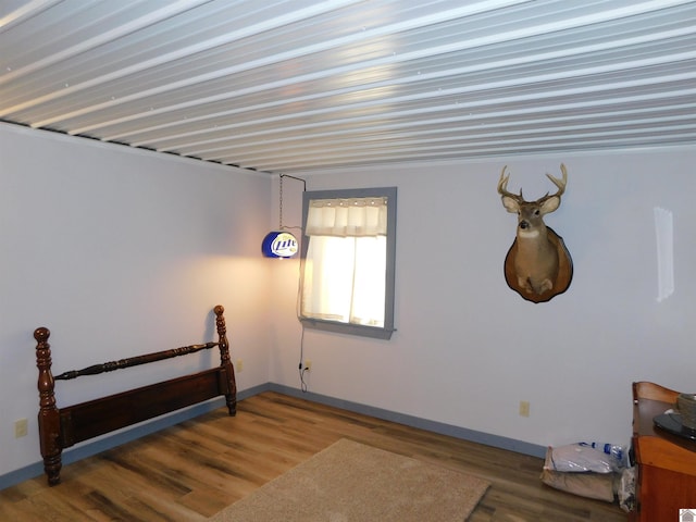 interior space featuring wood finished floors and baseboards