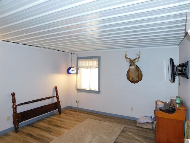 interior space featuring baseboards and wood finished floors