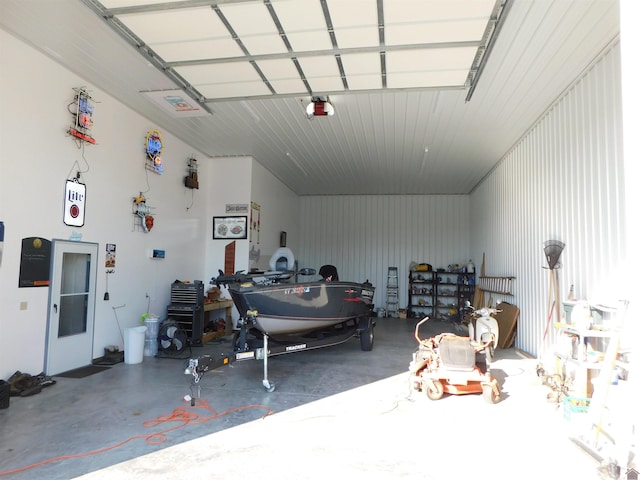 garage with a garage door opener and metal wall