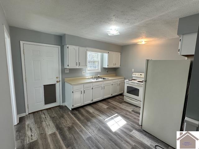 kitchen with white appliances, dark wood-style flooring, a sink, light countertops, and white cabinetry