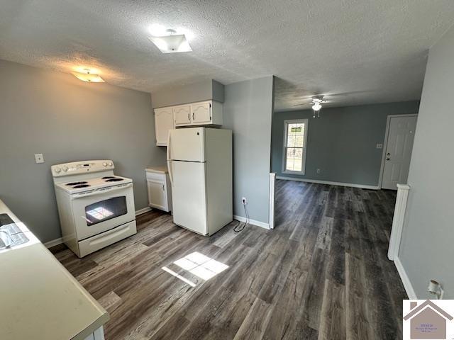 kitchen featuring white appliances, baseboards, dark wood-type flooring, white cabinets, and a textured ceiling